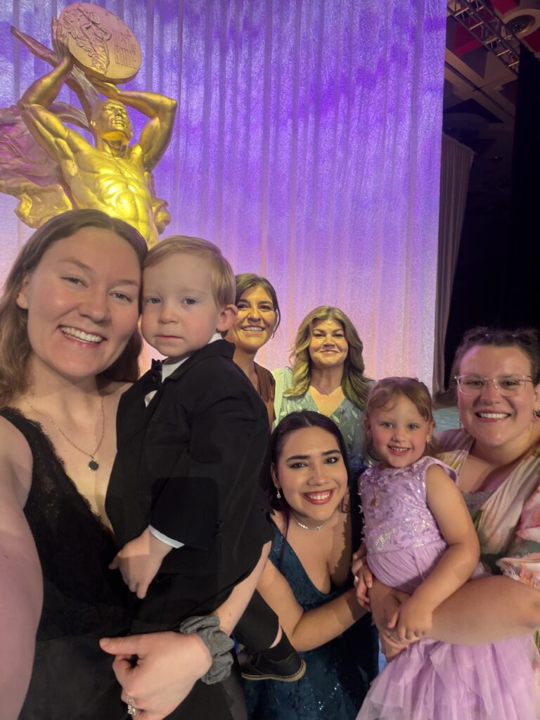 HOALiving Representatives take selfie in front of Best of State award statue