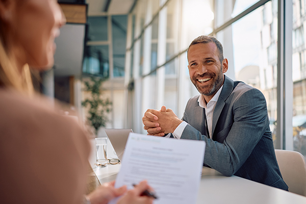Happy HOA board member communicating with his coworker while learning to understand hoa governing documents.