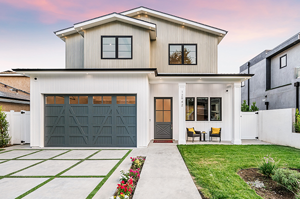 An exterior view of a contemporary new home in suburban HOA. Property Insurance.