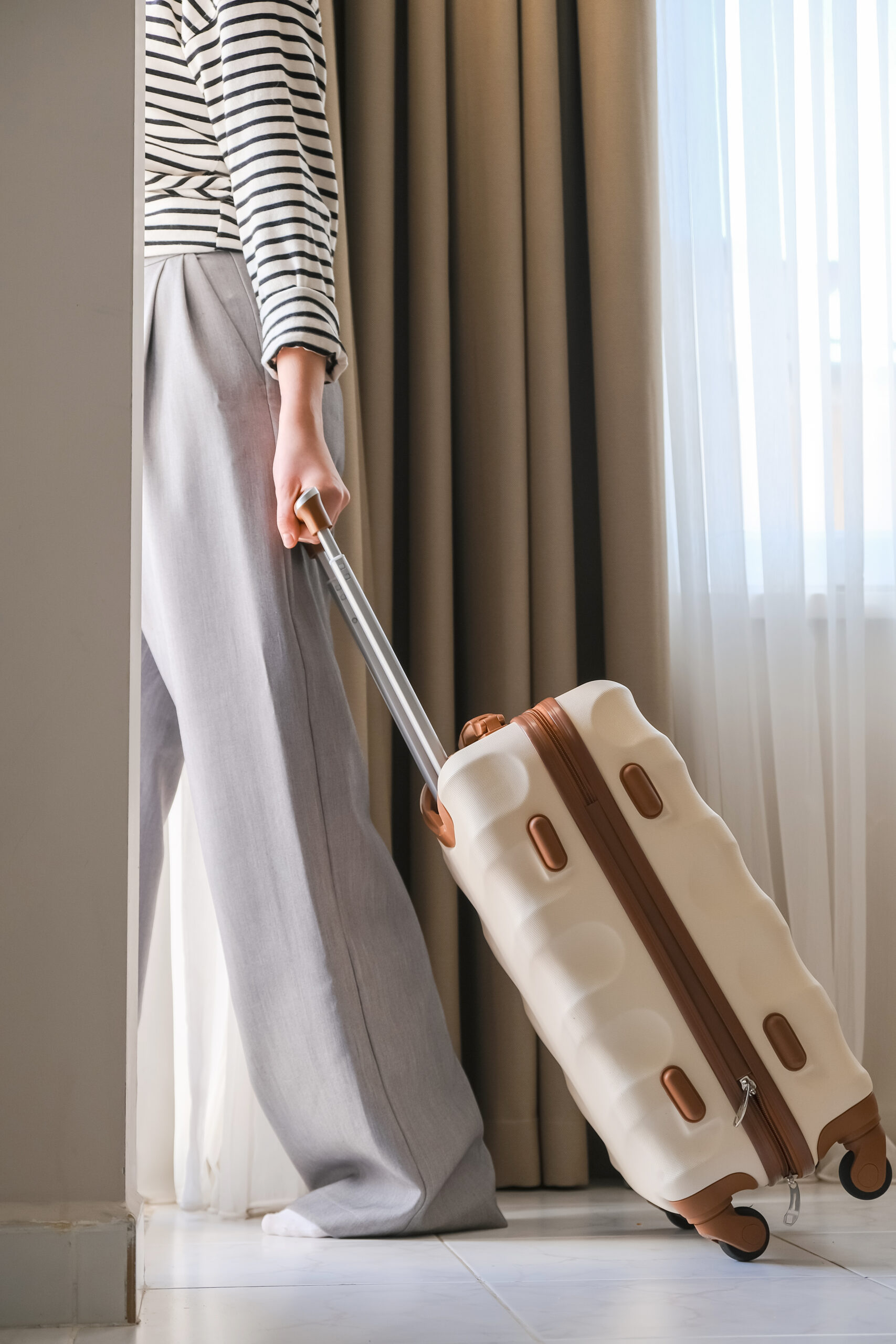 Woman packing luggage suitcase preparing for travel. short term rentals and leasing in an hoa.